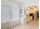 View of the dining room with a window and built-in display cabinet, leading to the kitchen at 255 Lexington Dr, Daytona Beach, FL 32114