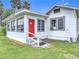 Charming home with a bright red door and well-manicured lawn at 255 Lexington Dr, Daytona Beach, FL 32114
