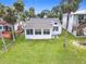 Charming single-story home with a large sunroom and a well-manicured lawn with mature landscaping at 255 Lexington Dr, Daytona Beach, FL 32114