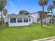 Charming waterfront property featuring lush green lawns and multi-story buildings with outdoor stairs at 255 Lexington Dr, Daytona Beach, FL 32114