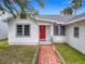 Charming single-story home featuring a red front door and a unique mosaic-tiled walkway at 255 Lexington Dr, Daytona Beach, FL 32114