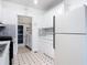 Functional kitchen with white cabinets, tile backsplash, and checkered flooring at 255 Lexington Dr, Daytona Beach, FL 32114