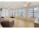 Living room with three ceiling fans and large windows providing waterfront views at 255 Lexington Dr, Daytona Beach, FL 32114