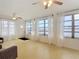 A bright living room boasting water views from the many windows with sheer curtains at 255 Lexington Dr, Daytona Beach, FL 32114