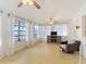 Bright living room featuring many windows with sheer curtains and ceiling fans at 255 Lexington Dr, Daytona Beach, FL 32114