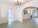 Spacious living room with green floors, chandelier, and arched entryways to other rooms at 255 Lexington Dr, Daytona Beach, FL 32114