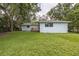 The property features a spacious backyard and lush greenery at 2617 Pine Tree Dr, Edgewater, FL 32141