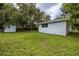 Exterior shot of the backyard, featuring a storage shed and lush greenery at 2617 Pine Tree Dr, Edgewater, FL 32141