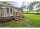 The property features a spacious backyard with a wooden deck and steps at 2617 Pine Tree Dr, Edgewater, FL 32141