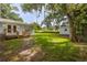 The property features a spacious backyard with a wooden deck, storage shed, and lush greenery at 2617 Pine Tree Dr, Edgewater, FL 32141