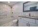 Updated bathroom features modern tiling in the shower and on the floor and granite countertop vanity at 2617 Pine Tree Dr, Edgewater, FL 32141