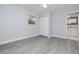 Neutral bedroom with light-gray paint, ceiling fan, light-wood-look flooring, closet, and white trim at 2617 Pine Tree Dr, Edgewater, FL 32141