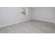 The bedroom features a hardwood floor, a window with coverings, and light gray colored walls at 2617 Pine Tree Dr, Edgewater, FL 32141