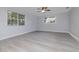 Spacious bedroom with modern flooring, ceiling fan, and large windows at 2617 Pine Tree Dr, Edgewater, FL 32141