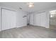 Neutral bedroom with light-gray paint, light-wood-look flooring, two closets and bathroom access at 2617 Pine Tree Dr, Edgewater, FL 32141