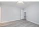 Neutral bedroom with light-gray paint, ceiling fan, light-wood-look flooring, and white trim at 2617 Pine Tree Dr, Edgewater, FL 32141