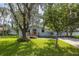 Charming single-story home featuring a well-maintained lawn and mature trees at 2617 Pine Tree Dr, Edgewater, FL 32141