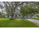 Charming single-story home featuring a well-maintained lawn and mature trees at 2617 Pine Tree Dr, Edgewater, FL 32141