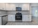 Bright kitchen features stainless appliances, white cabinets, modern backsplash, and tile flooring at 2617 Pine Tree Dr, Edgewater, FL 32141