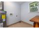 Utility room featuring a hot water tank and a connection for a washer and dryer at 2617 Pine Tree Dr, Edgewater, FL 32141