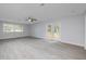 Spacious living area with hardwood floors and lots of natural light from the sliding doors at 2617 Pine Tree Dr, Edgewater, FL 32141