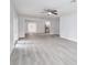 Open living space featuring modern flooring, ceiling fan, and ample natural light at 2617 Pine Tree Dr, Edgewater, FL 32141