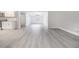 Bright, open-concept living space with modern floors connecting the kitchen and living areas at 2617 Pine Tree Dr, Edgewater, FL 32141