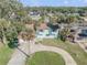 Two-story home with circular drive, garage, complemented by lush greenery and a view of the surrounding neighborhood at 2715 Pine Tree Dr, Edgewater, FL 32141