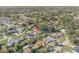 A picturesque aerial shot captures the neighborhood, featuring a mix of homes and mature foliage at 2715 Pine Tree Dr, Edgewater, FL 32141