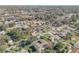 Scenic aerial view of neighborhood homes, featuring mature trees and proximity to a serene lake at 2715 Pine Tree Dr, Edgewater, FL 32141