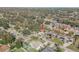 Neighborhood aerial view showcasing a home among lush trees, nearby properties, and community streets at 2715 Pine Tree Dr, Edgewater, FL 32141