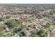 Scenic aerial view of neighborhood homes, featuring mature trees and proximity to a serene lake at 2715 Pine Tree Dr, Edgewater, FL 32141