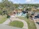 Two-story home featuring a circular driveway, attached garage, complemented by mature palm trees and lush landscaping at 2715 Pine Tree Dr, Edgewater, FL 32141
