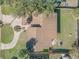 Aerial view showing a home's roof, driveway, and surrounding yard with mature trees and landscaping at 2715 Pine Tree Dr, Edgewater, FL 32141