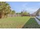 Lush backyard featuring a fire pit, privacy fence, and well-manicured lawn offers a serene outdoor retreat at 2715 Pine Tree Dr, Edgewater, FL 32141
