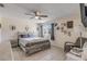Neutral bedroom features a gray bed frame, tile floors, and plenty of natural light at 2715 Pine Tree Dr, Edgewater, FL 32141