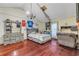 Spacious bedroom with hardwood floors, a bed, and a large dresser with sports decor at 2715 Pine Tree Dr, Edgewater, FL 32141