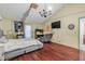 Bedroom with hardwood floors and neutral walls features a TV and comfortable seating at 2715 Pine Tree Dr, Edgewater, FL 32141