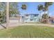 Inviting two-story home with circular driveway, garage, and mature palms creating curb appeal and a welcoming atmosphere at 2715 Pine Tree Dr, Edgewater, FL 32141