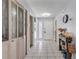 Inviting foyer with tiled floor, decorative wall art, glass paneled closet doors and charming seasonal accents at 2715 Pine Tree Dr, Edgewater, FL 32141