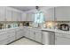 Well-maintained kitchen with stainless steel appliances, gray cabinets, and ample counter space at 2715 Pine Tree Dr, Edgewater, FL 32141