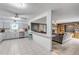 Updated kitchen seamlessly connects to the Gathering room with white cabinets and appliances at 2715 Pine Tree Dr, Edgewater, FL 32141