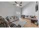 Vaulted living room features laminate flooring and a sliding door to the backyard at 2715 Pine Tree Dr, Edgewater, FL 32141