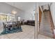 Expansive open concept living and dining area with tile floors and staircase access at 2715 Pine Tree Dr, Edgewater, FL 32141