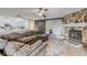 Open-concept living room with stone fireplace and view into the kitchen at 2715 Pine Tree Dr, Edgewater, FL 32141