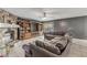 Inviting living room showcasing a stone fireplace, entertainment center, and plush seating at 2715 Pine Tree Dr, Edgewater, FL 32141