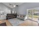 Bright living room with vaulted ceilings, laminate floors, and sliding door access to the backyard at 2715 Pine Tree Dr, Edgewater, FL 32141