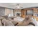 Comfortable living room with stone fireplace, built-in shelves, and a large sofa at 2715 Pine Tree Dr, Edgewater, FL 32141
