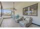 Relaxing sunroom offers comfortable wicker seating, tiled floors, and a ceiling fan for year-round enjoyment at 2715 Pine Tree Dr, Edgewater, FL 32141