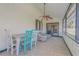 Bright sunroom featuring tiled floors, a ceiling fan, and comfortable wicker furniture for relaxing at 2715 Pine Tree Dr, Edgewater, FL 32141